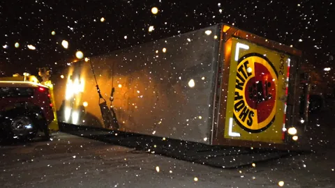Overturned trailer recovery at night in the snow