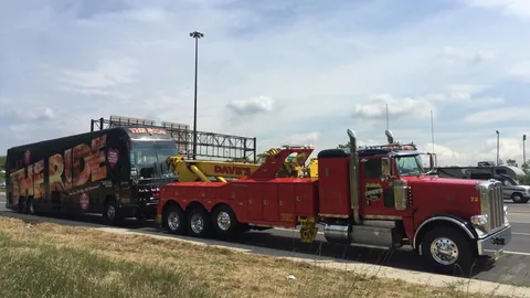Dave's wrecker with a tour bus behind it