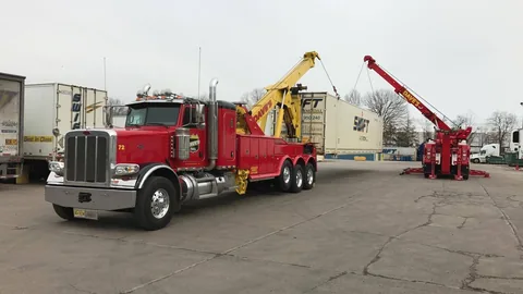 Dave's wrecker and rotator handling a shipping container