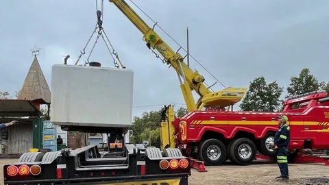 Dave's crane lifting a rooftop unit into place