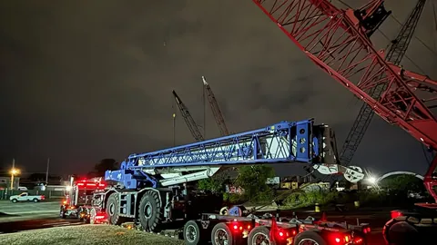 Crane lift at night with Dave's heavy hauling equipment