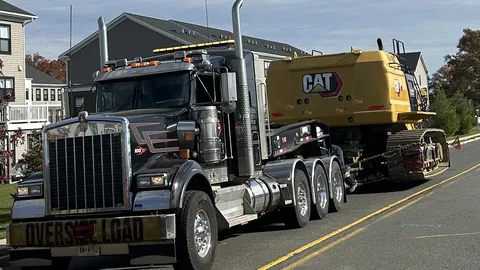 Dave's oversize load heavy hauler carrying a CAT excavator