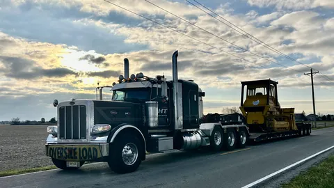 Heavy hauler with an oversize load carrying a dozer