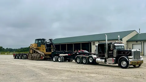 Dave's heavy haul tractor with lowboy beside a loaded dozer