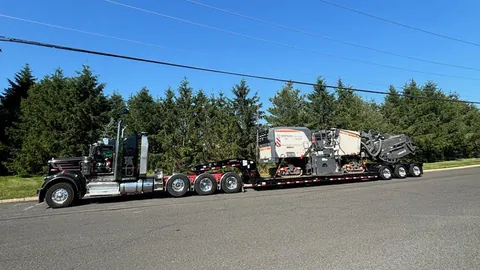 Heavy haul tractor and trailer moving construction equipment