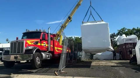 Dave's wrecker crane lifting a load