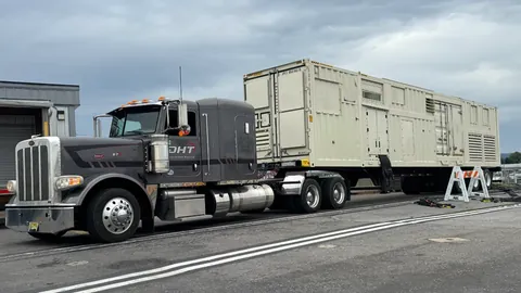 Heavy hauler transporting a large generator