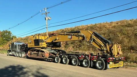 Heavy hauler carrying a CAT excavator on a lowboy