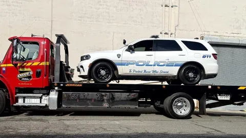 Dave's rollback carrying a police SUV