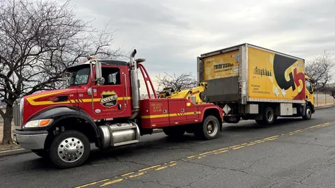 Dave's wrecker towing a box truck