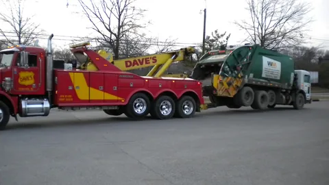 Dave's heavy wrecker towing a garbage truck