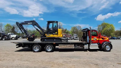 Dave's rollback hauling a mini excavator