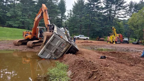 Dave's recovery crew pulling a vehicle out of a wet embankment