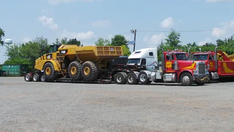 Dave's oversize load hauler carrying a large dump truck